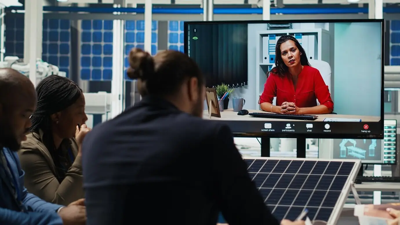 Engineers at a photovoltaics plant design solar cell prototypes in a video call meeting.